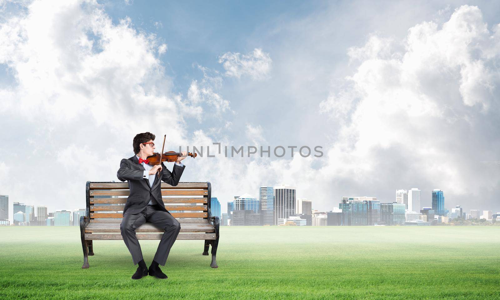 Young businessman plays the violin by adam121