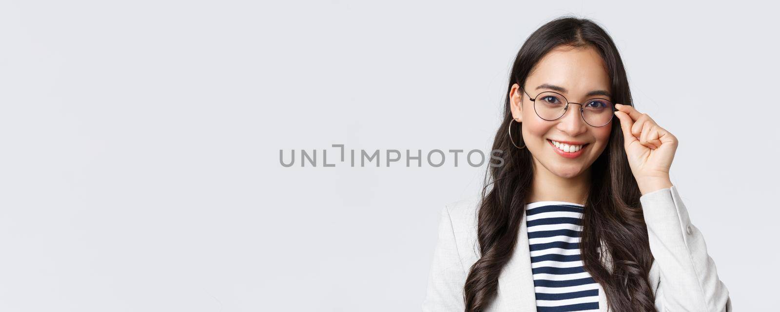 Business, finance and employment, female successful entrepreneurs concept. Talented young asian female IT programmer in glasses, customer support manager smiling at camera.