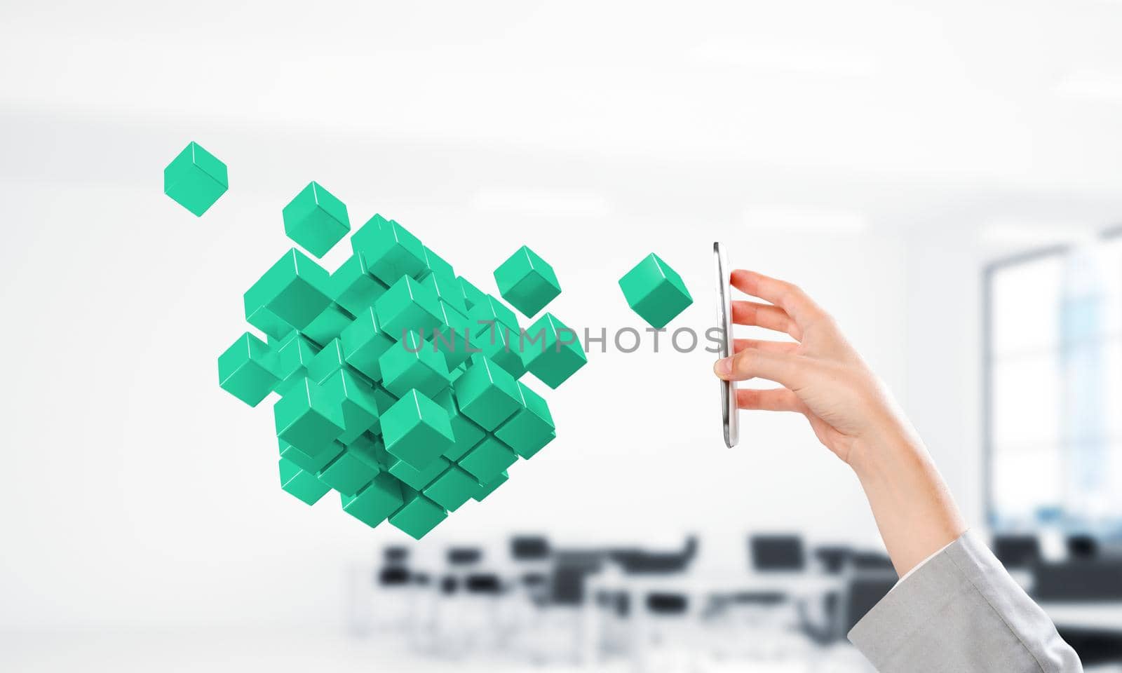 Close of businesswoman hand holding smartphone and cube figure out of screen. Mixed media