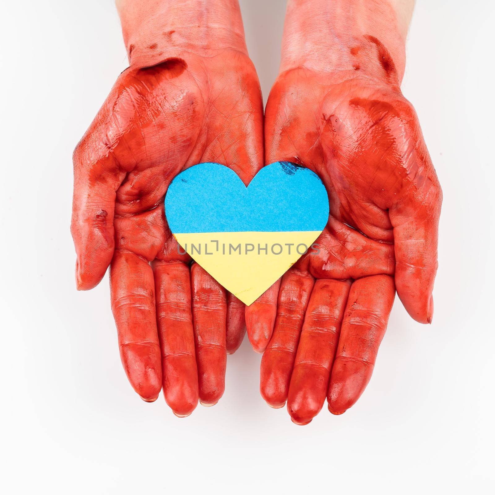 Woman with hands covered in blood holding a heart with the flag of ukraine on a white background. by mrwed54
