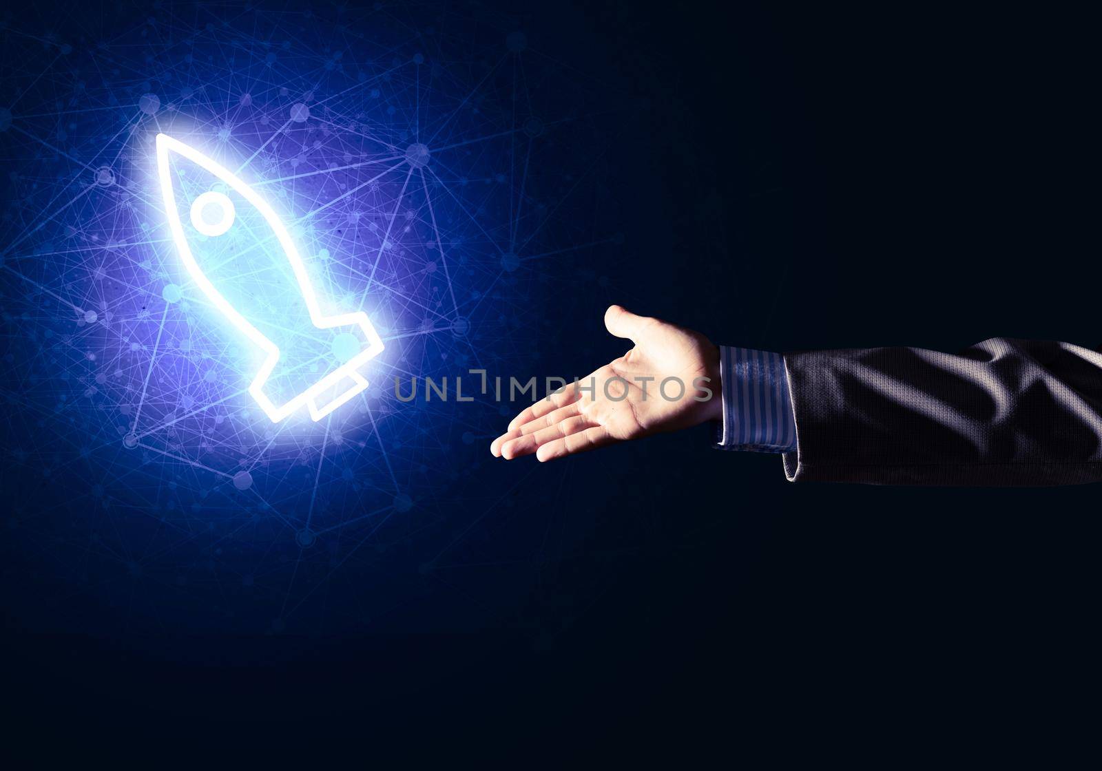 Rocket glowing icon and businessman hand on dark background