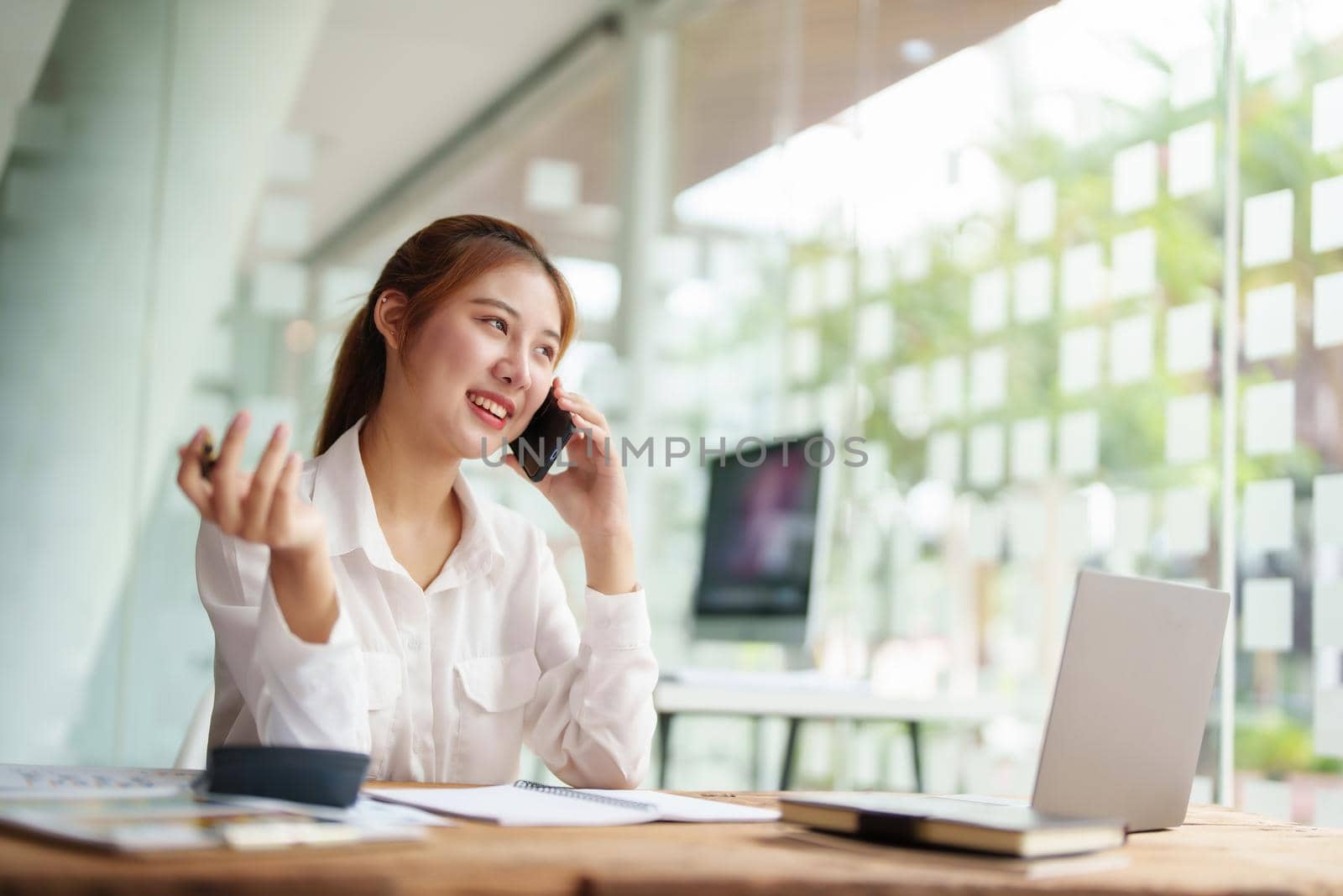 data analysis, plan, marketing, accounting, audit, asian business woman holding smart phone of planning marketing use statistical data sheet and computer to present marketing plan project at meeting. by Manastrong