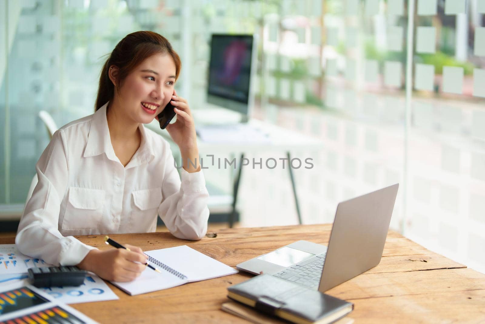 data analysis, plan, marketing, accounting, audit, asian business woman holding smart phone of planning marketing use statistical data sheet and computer to present marketing plan project at meeting. by Manastrong