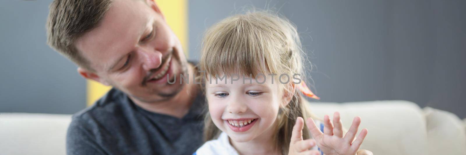 Portrait of cheerful daughter and smiling father spend time together, weekend with dad, parent interested in child life. Childhood, parenthood, leisure, holiday, fun, game concept