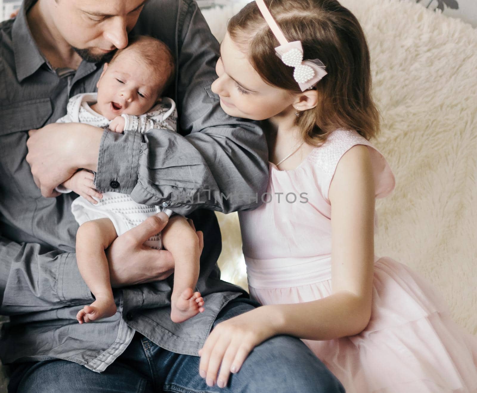 happy married couple with their three children. by SmartPhotoLab