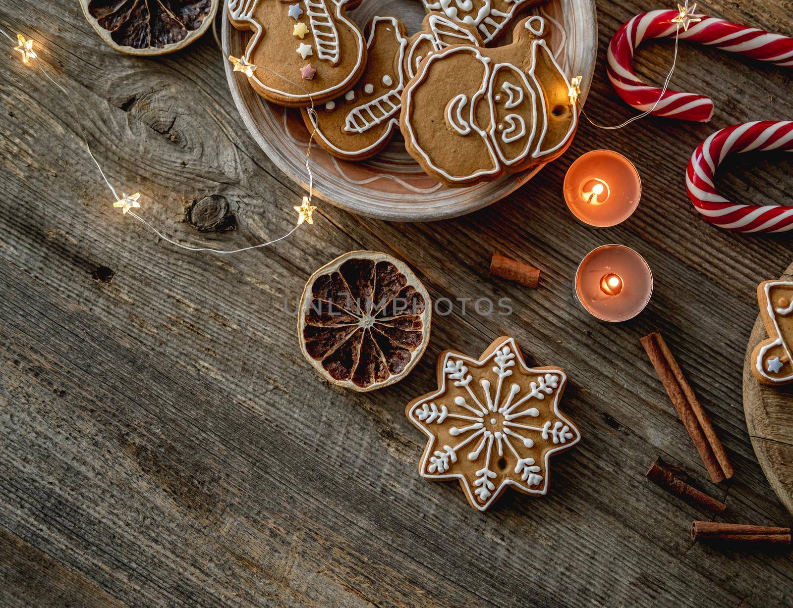 Top view of festive gingerbread beside cocoa and christmas decorations