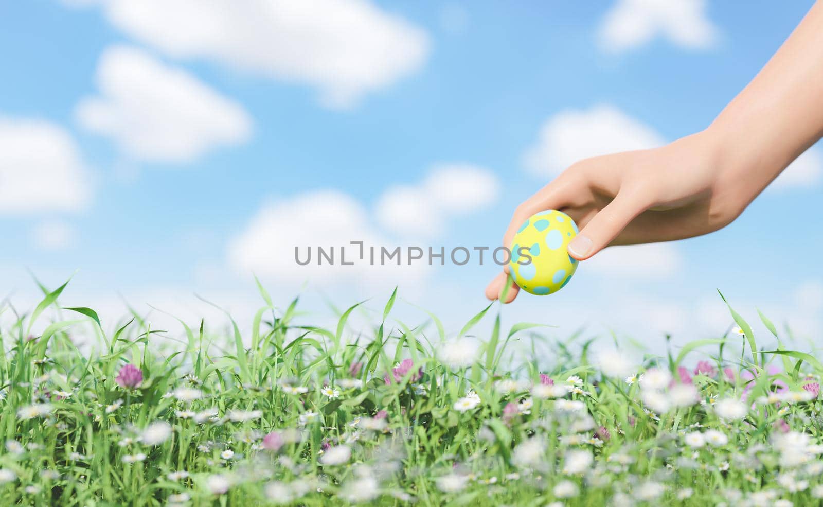 hand picking up an easter egg in a field by asolano