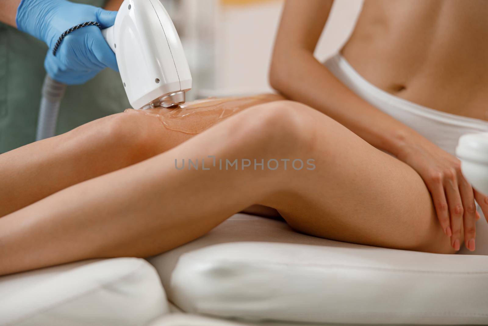 Closeup of legs skin photo epilation with ipl machine in beauty salon by Yaroslav_astakhov