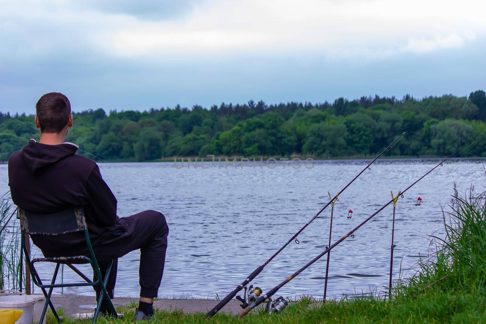 Close-up of a fishing rod wheel, a man is fishing. Nature. selective focus
