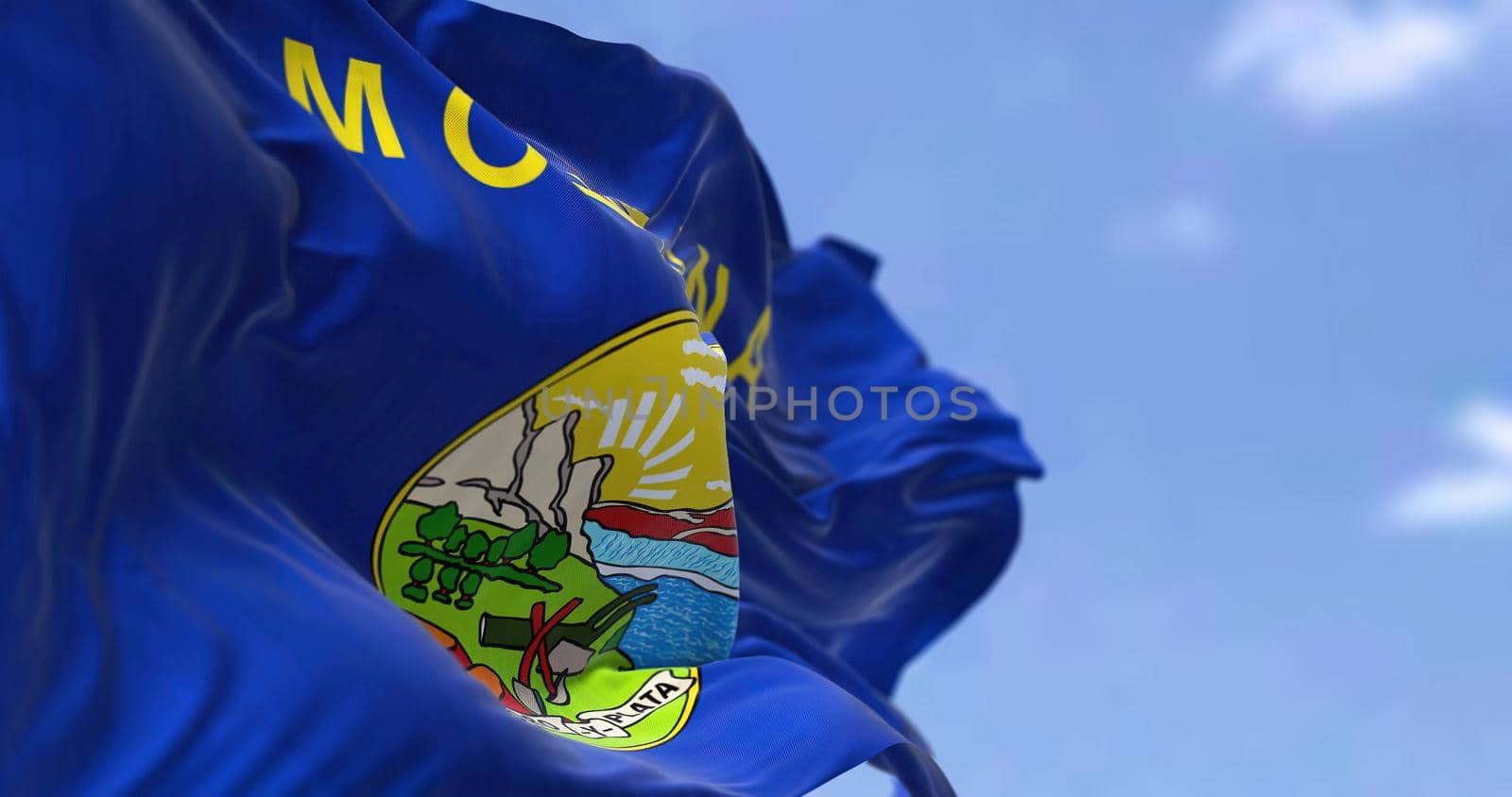 The US state flag of Montana waving in the wind. Montana is a state in the Mountain West subregion of the Western United States. Democracy and independence.