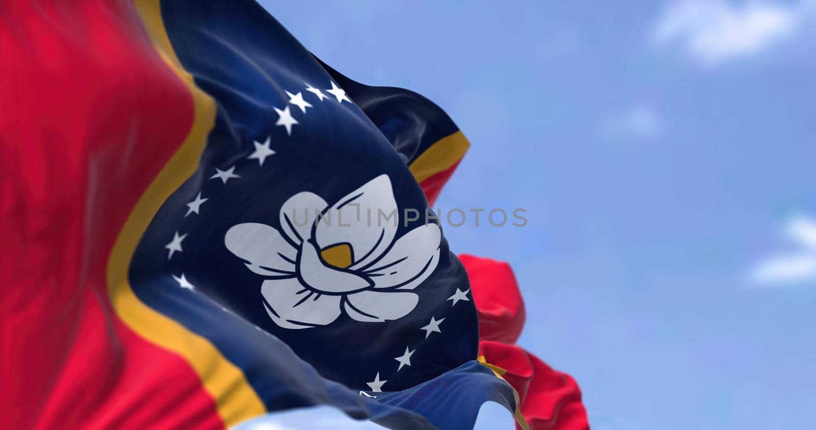 The US state flag of Mississippi waving in the wind. Mississippi is a state in the Southeastern region of the United States. Democracy and independence.