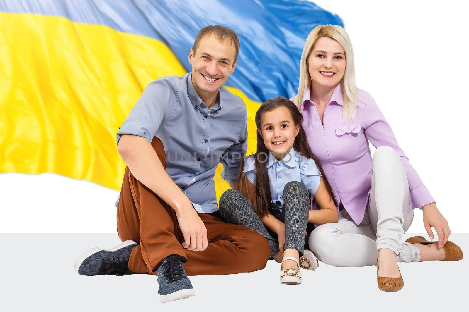 family with flag of ukrainet, yellow and blue colors of the Ukrainian flag. Family, unity, support,. Russia's invasion of Ukraine, a request for help to the world community. by Andelov13