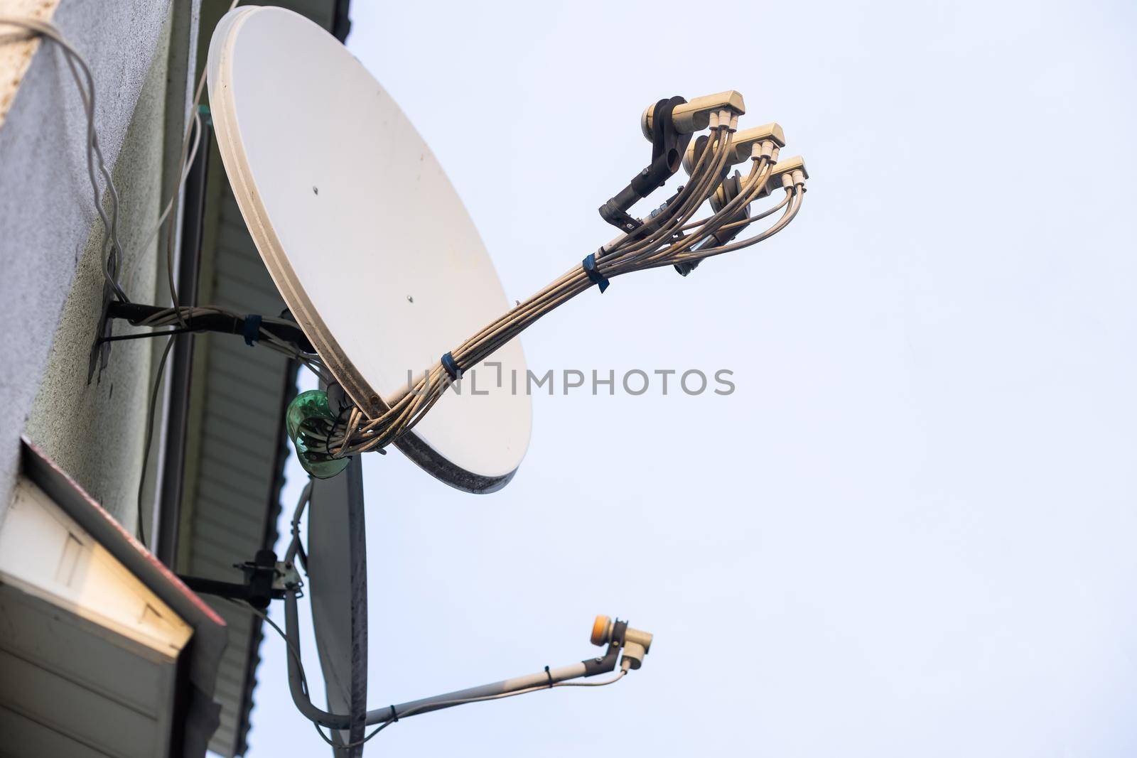 satellite dish and television antenna on roof top.