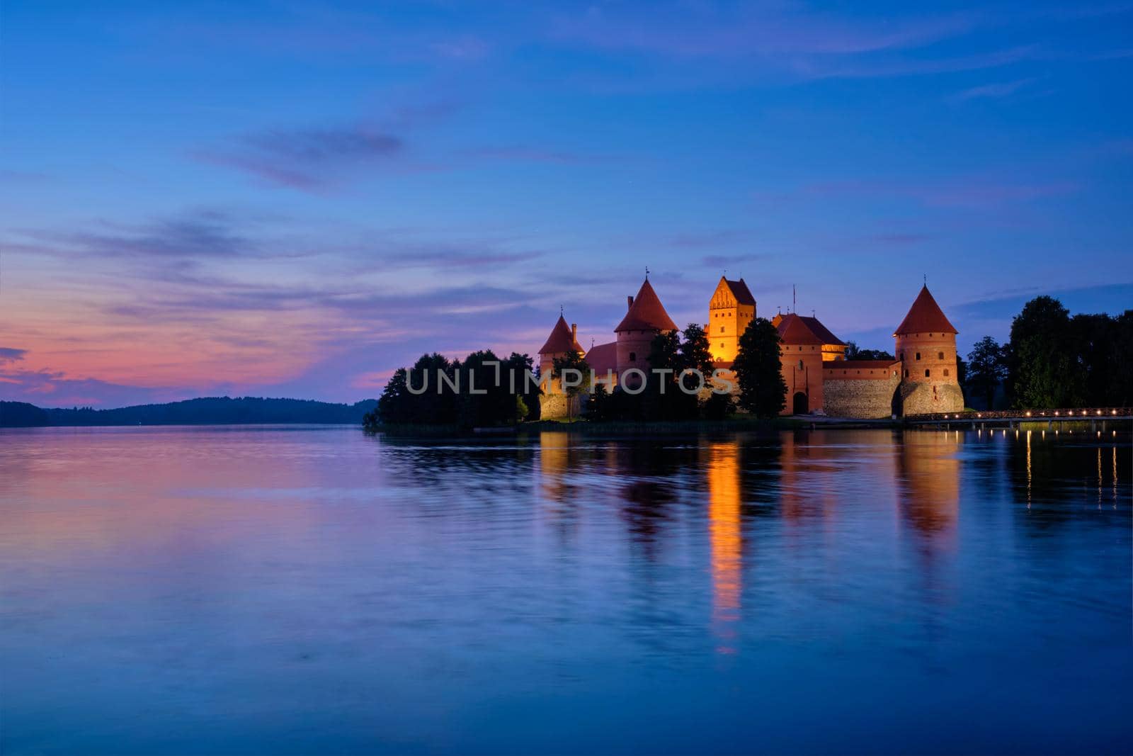 Night view of Trakai Island Castle in lake Galve illuminated in the evening, Lithuania