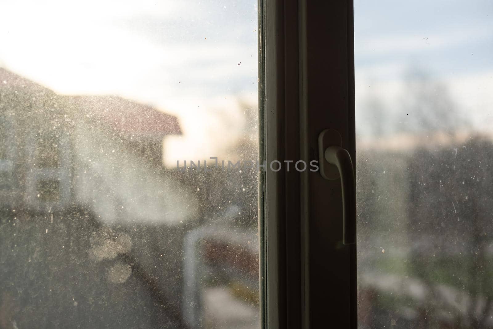 Window with very dirty and dusty glass in daylight by Andelov13