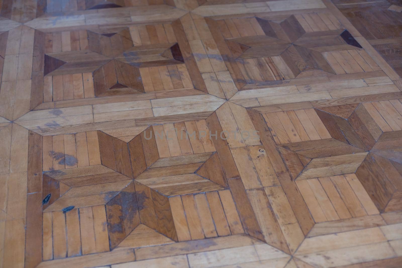 Texture of old worn parquet floor, close up.