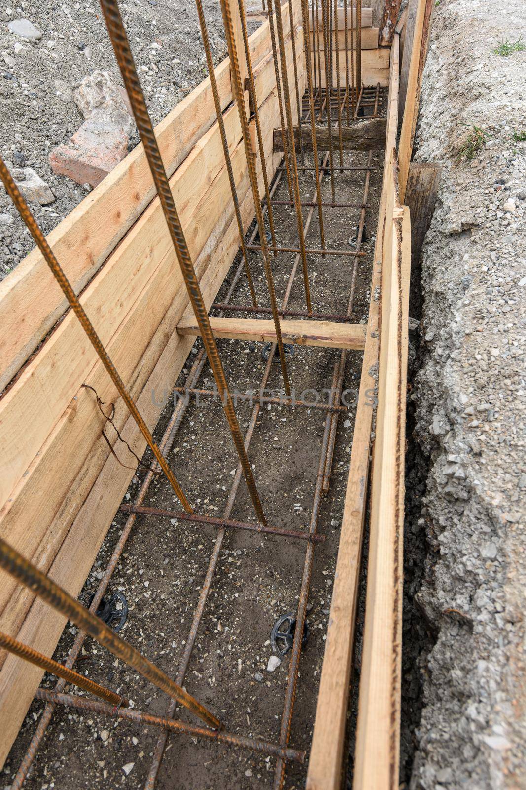Reinforcement of the strip foundation, lower layer of reinforcement, unfinished formwork a