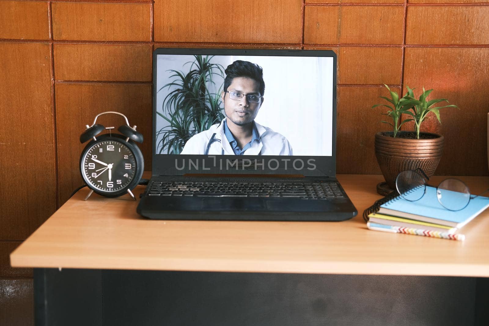young asian doctor on laptop screen in video chat