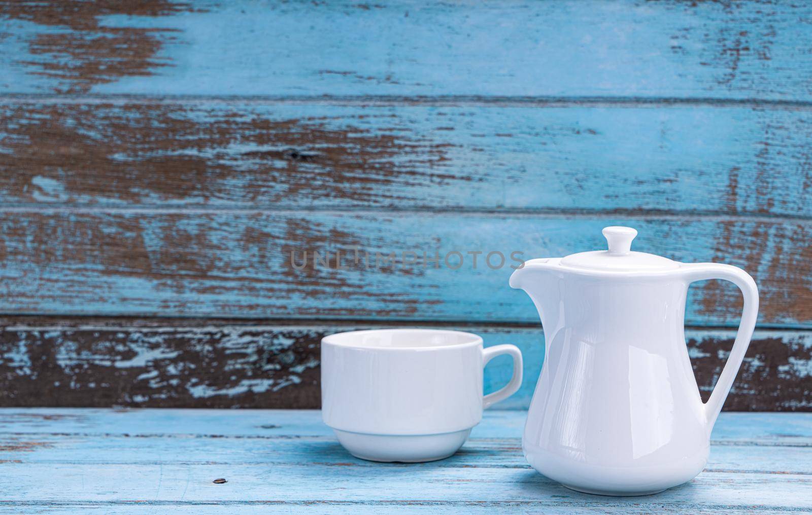 Set of white teacups on a blue wooden floor by Buttus_casso