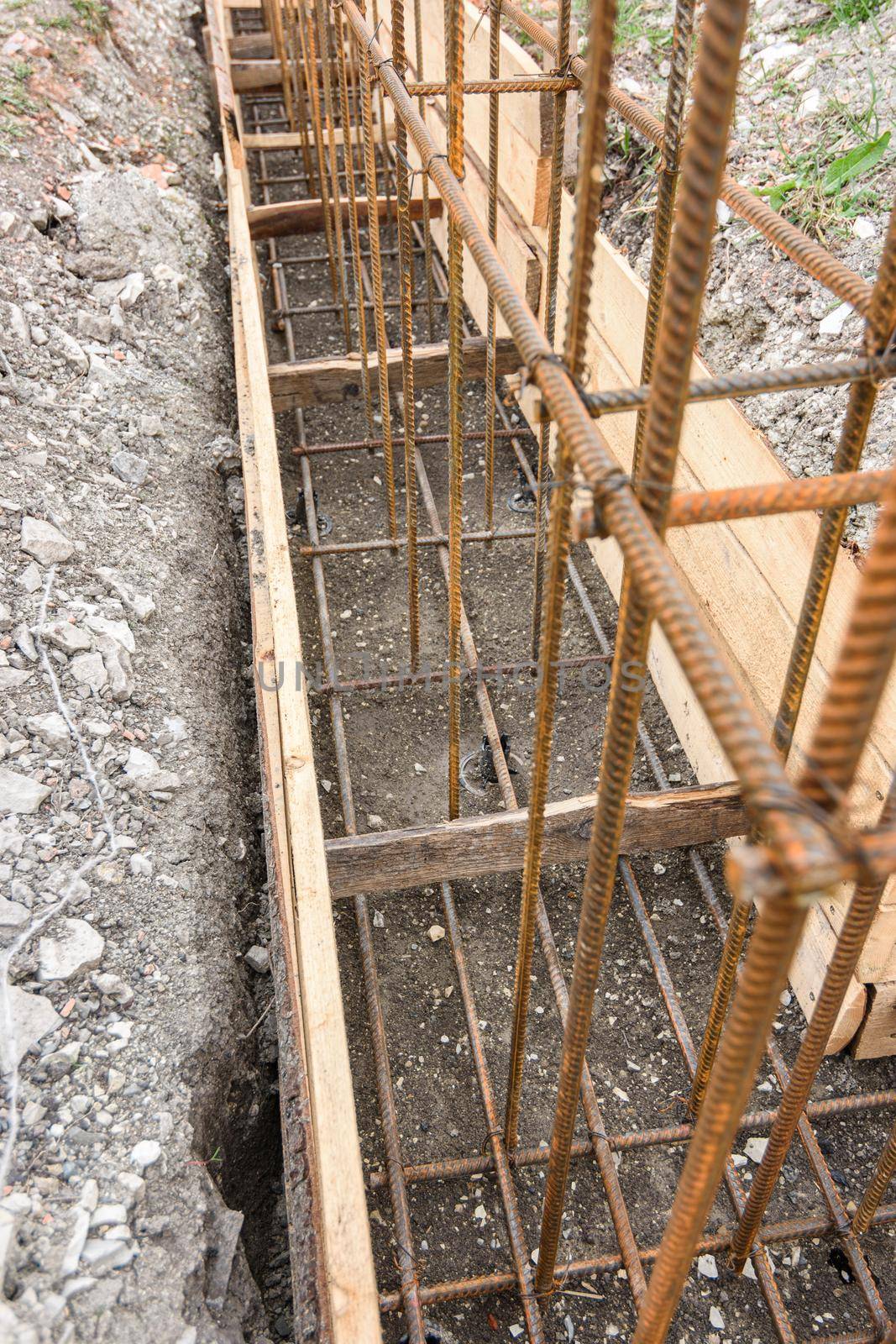 Reinforcement of the strip foundation with metal reinforcement in a trench with formwork a