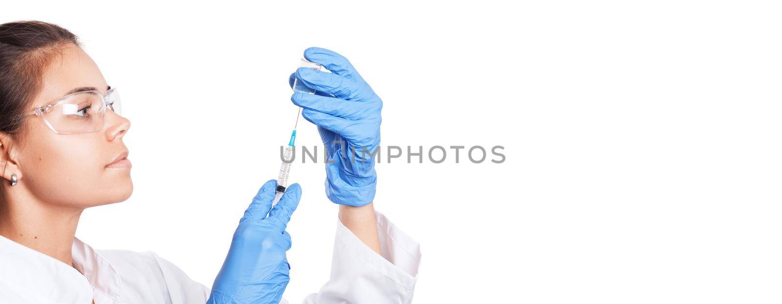 Doctor holding a syringe with vaccine against corona virus. by Taut