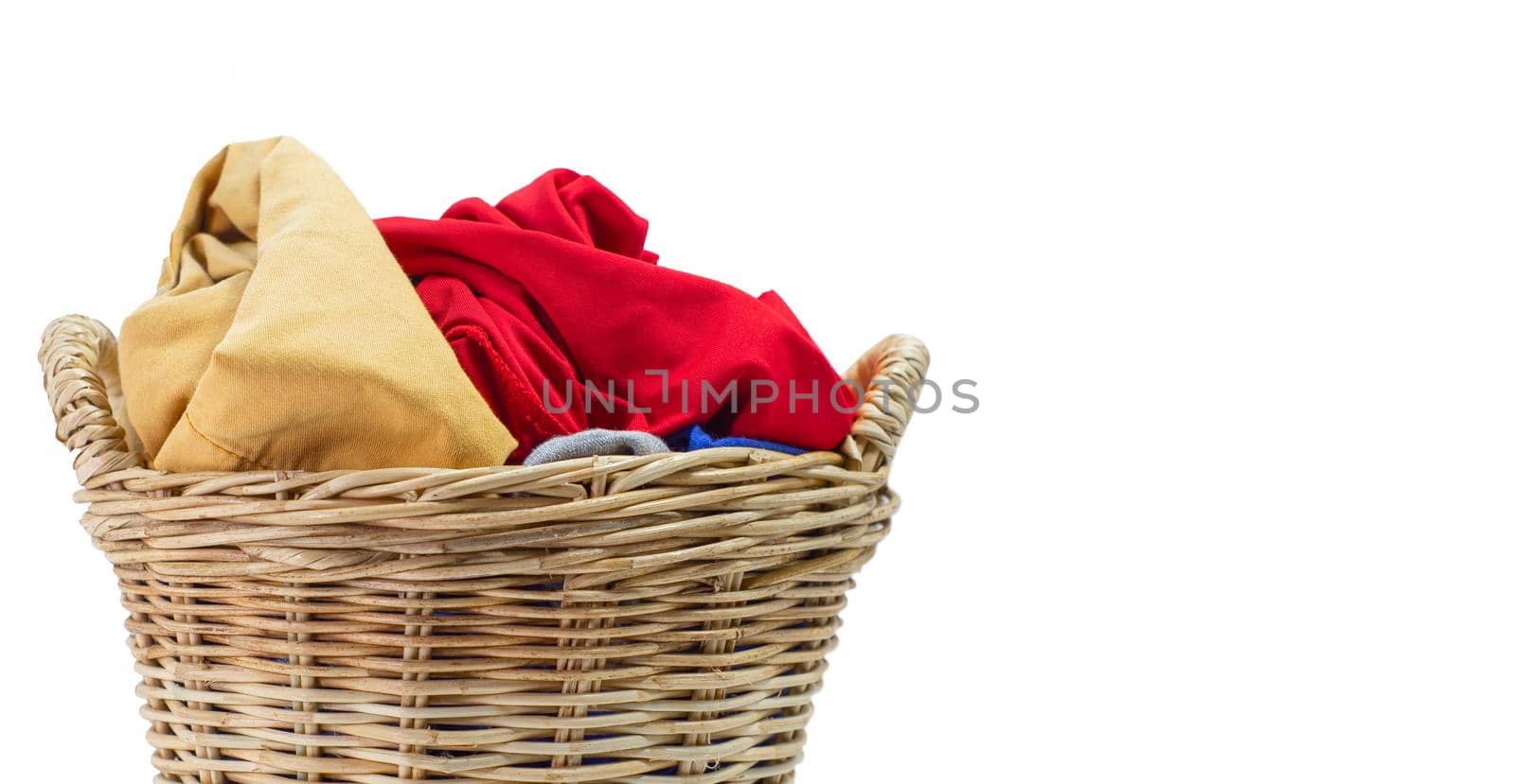 Clothes in a laundry wicker basket isolated on white background.