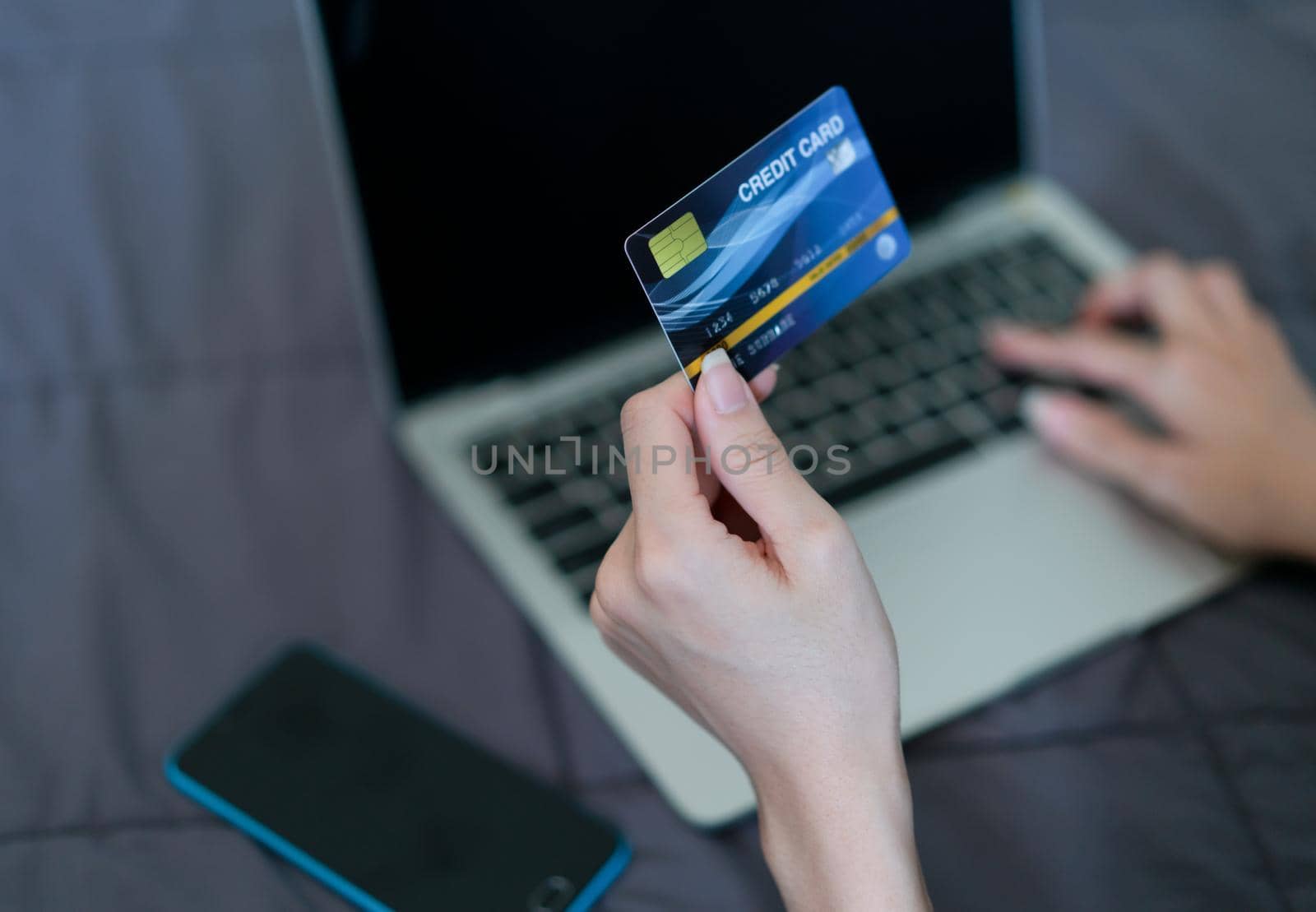 Hand woman holding credit card for shopping online.  Technology and modern business by Buttus_casso