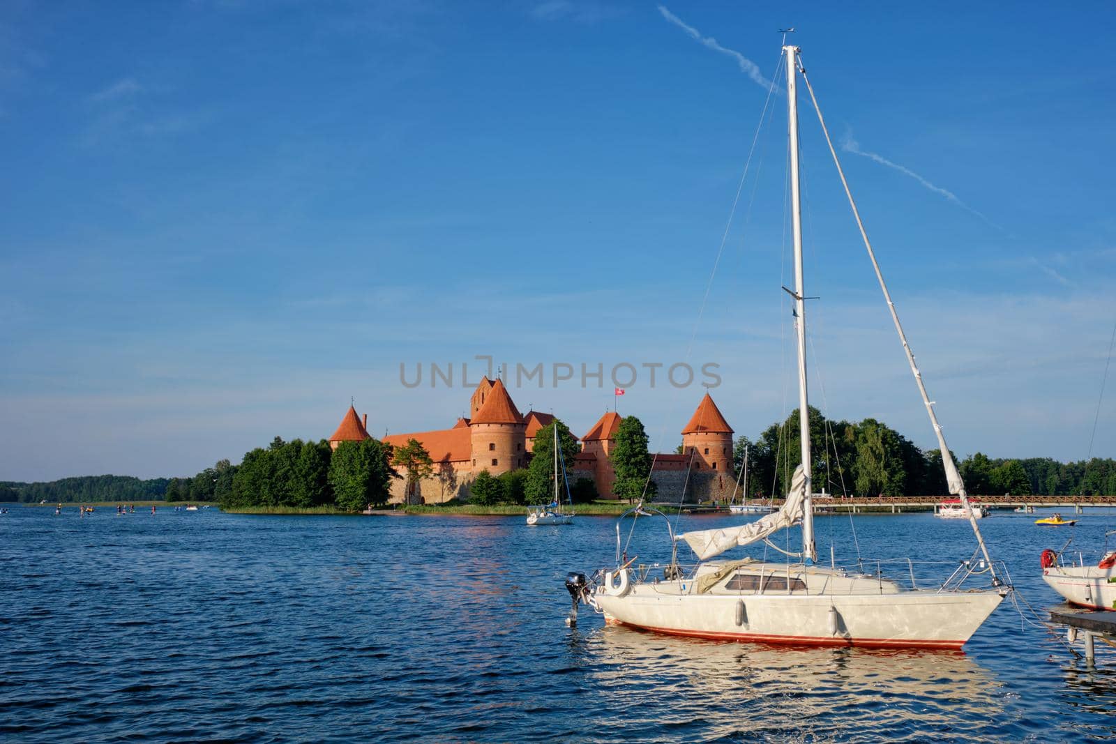 Yacht boats and Trakai Island Castle in lake Galve in day, Lithuania. Trakai Castle is one of major tourist attractions of Lituania