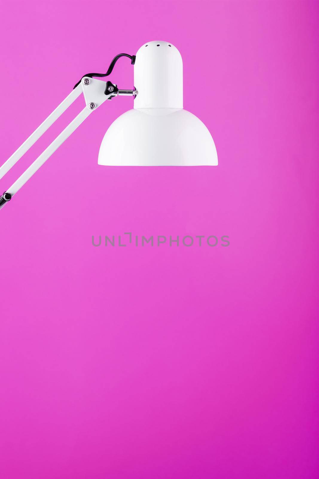 White table office lamp on pink background with space for text and idea concept