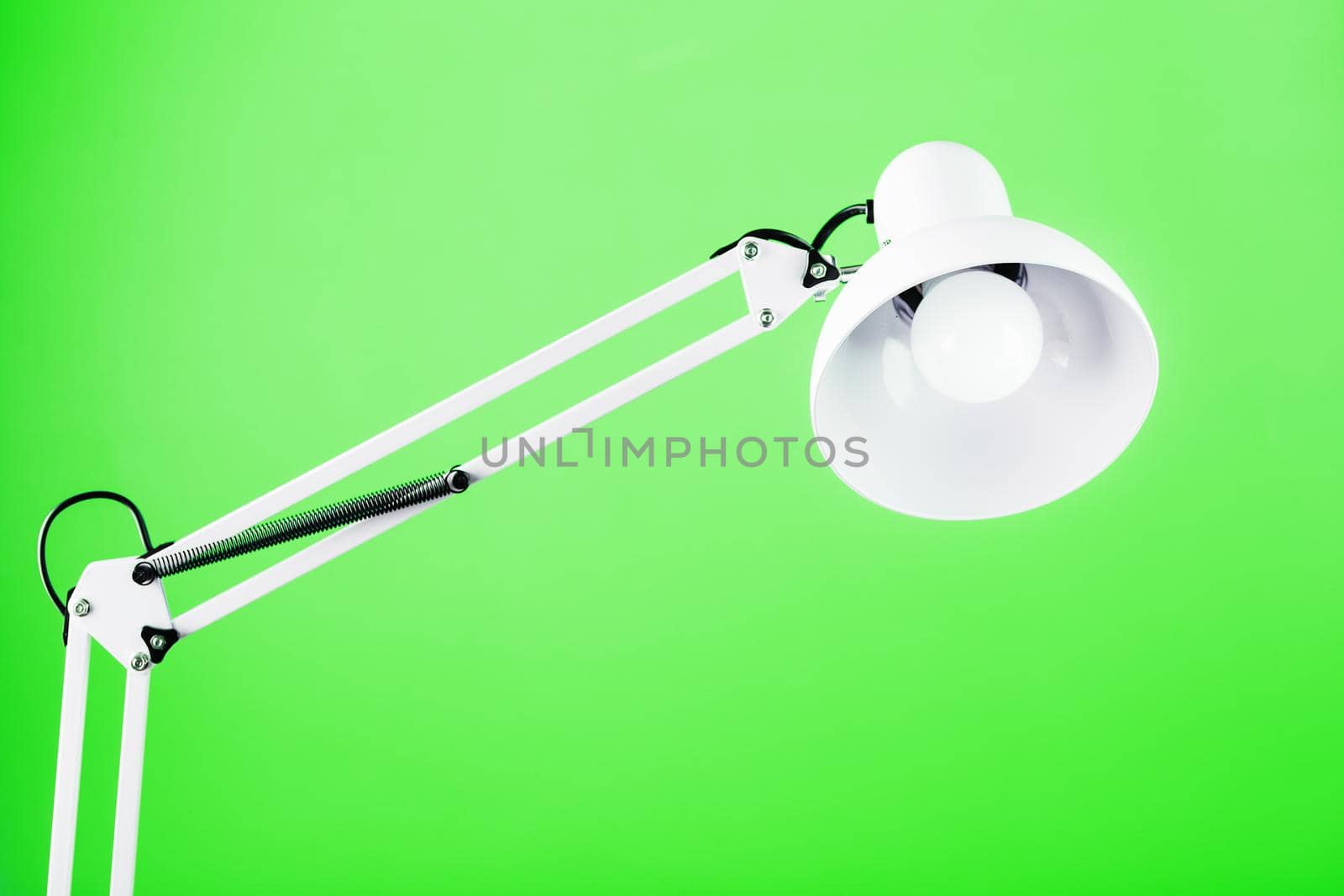 White table office lamp on green background with space for text and idea concept