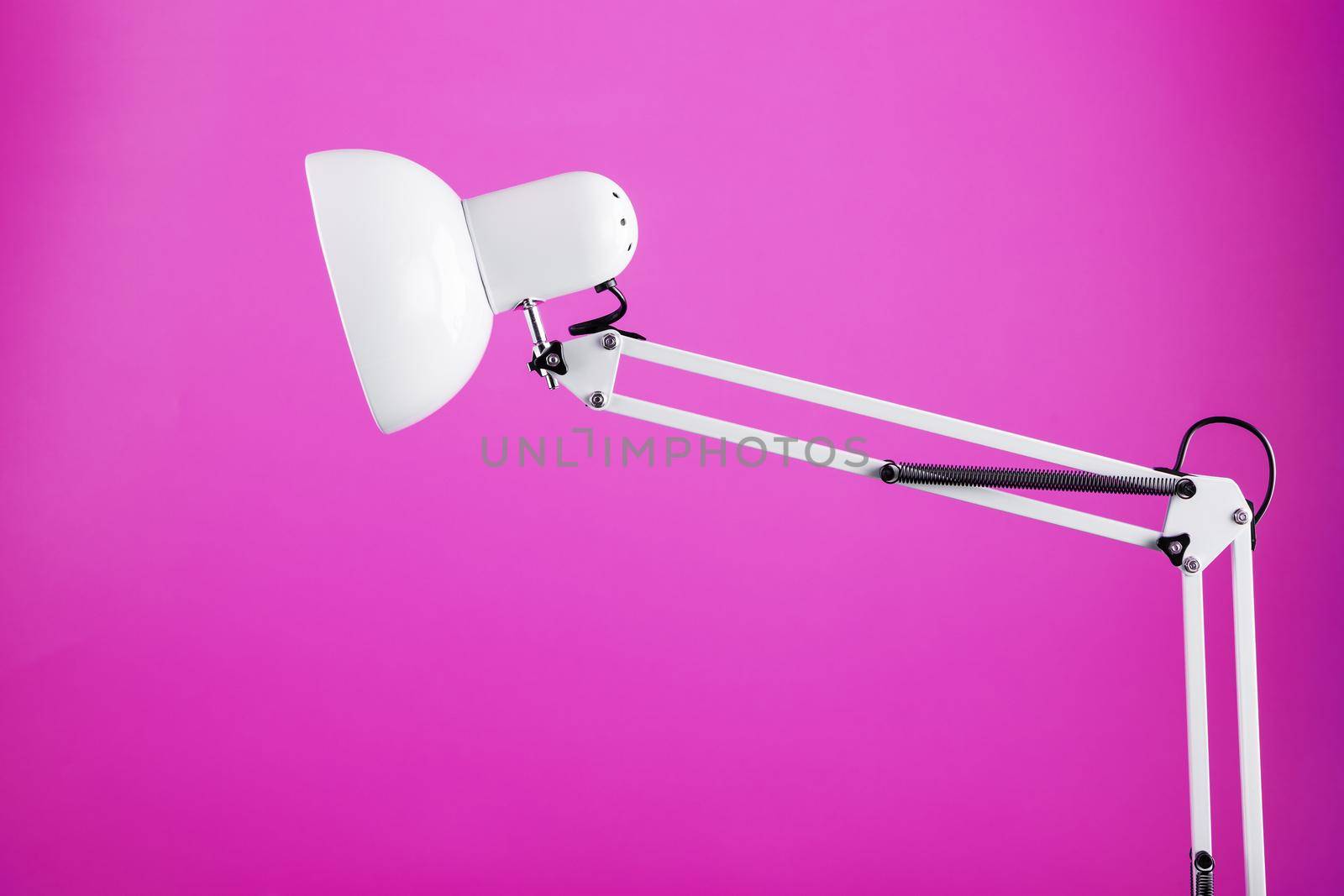 White table office lamp on pink background with space for text and idea concept