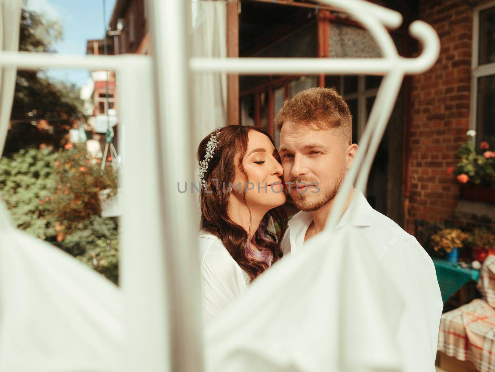 Bride and groom at the garden wearing wedding cloth grain effect by Symonenko