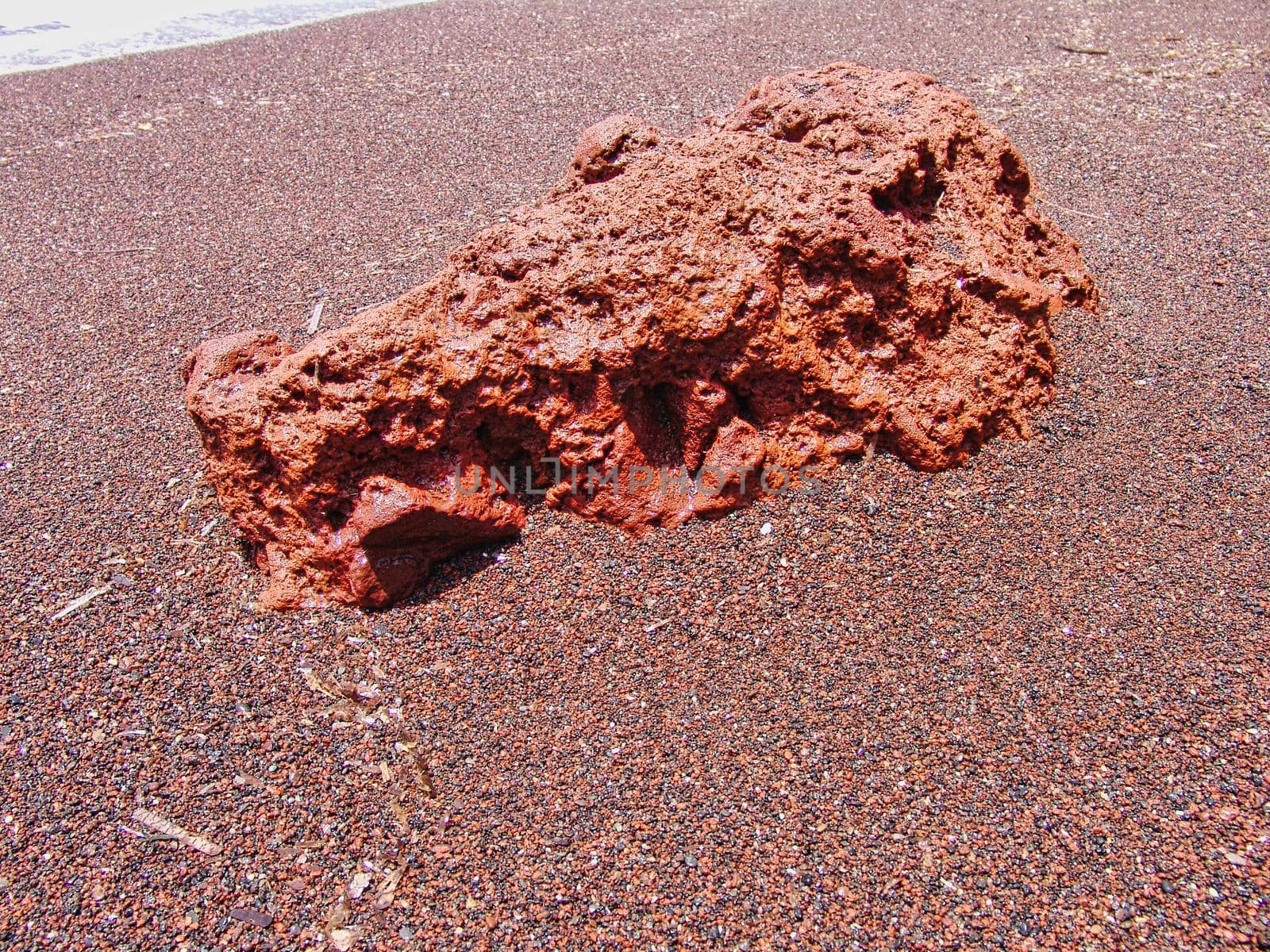 Beach is covered with fine black sand, and drops off sharply into the water.