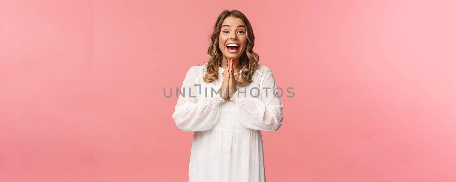 Enthusiastic and excited, happy emotive blond girl applause, clasping hands in thrill and amazement as seeing something really wonderful and cool, smiling as dream came true, pink background.