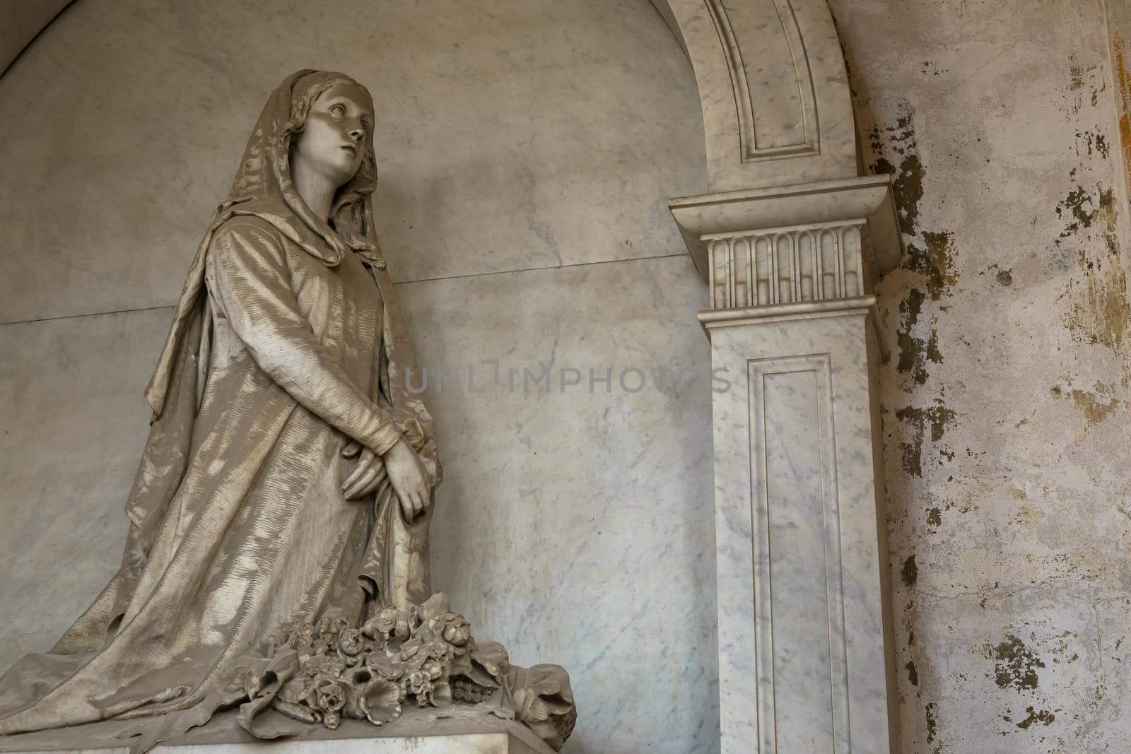 GENOA, ITALY - June 2020: antique statue, beginning 1800, made of marble, in a Christian Catholic cemetery - Italy