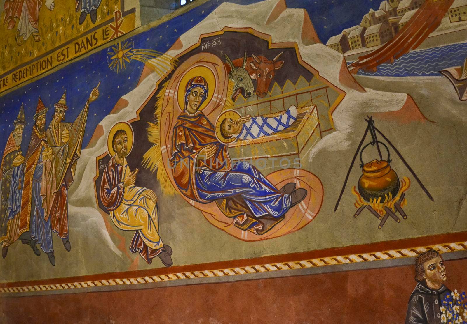 LE MANS, FRANCE - SEPTEMBER 17, 2017: Church St-Lazare with painted frescoes Christmas creche with Joseph Mary and small Jesus inside of artist Nikolay Greshniy