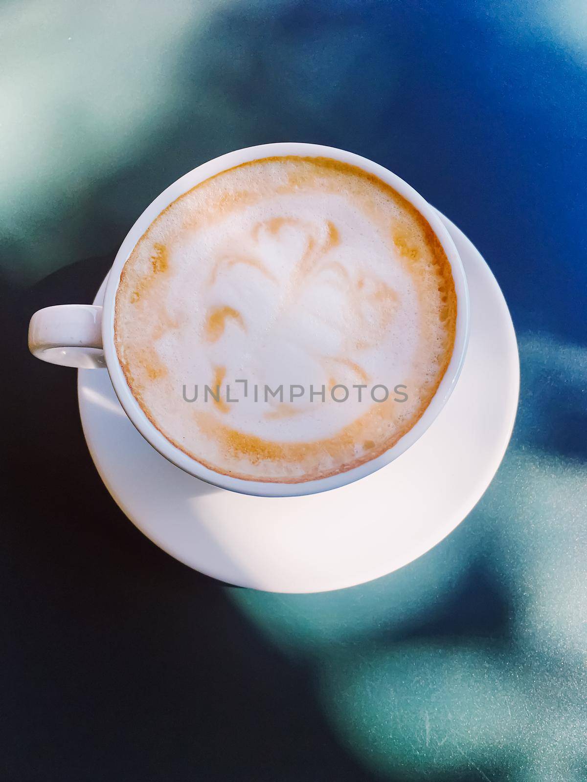 Cappuccino in summer cafe outdoors by Anneleven