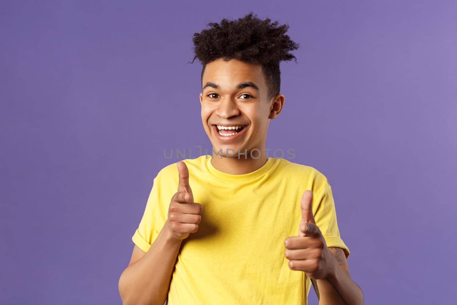 Believe in you. Portrait of cheerful young optimistic guy encuraging to keep going, pointing fingers at camera with happy upbeat smile, picking someone, praising or complimanting.