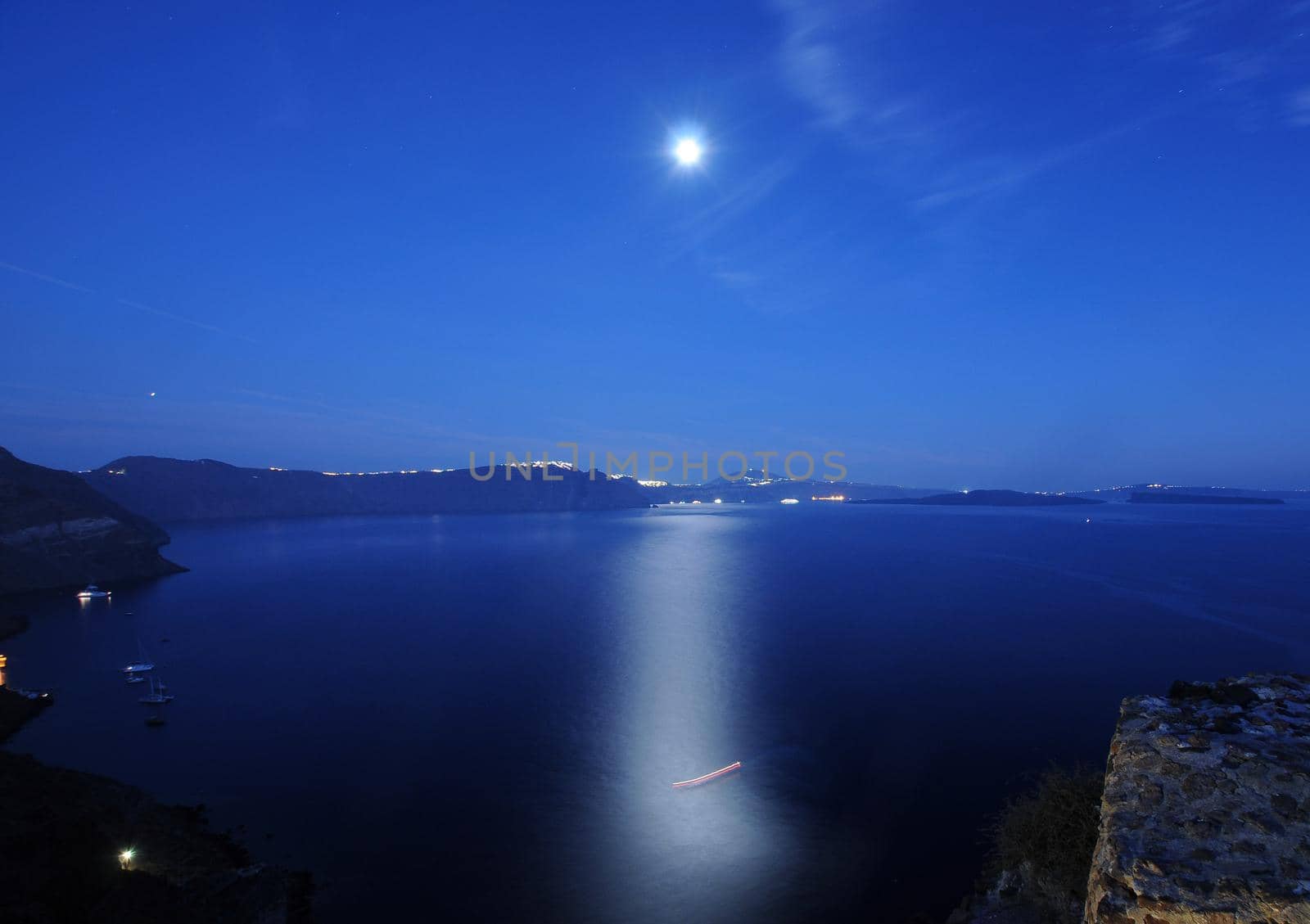 Scenic view of traditional cycladic Santorini houses in Oia village, full moon