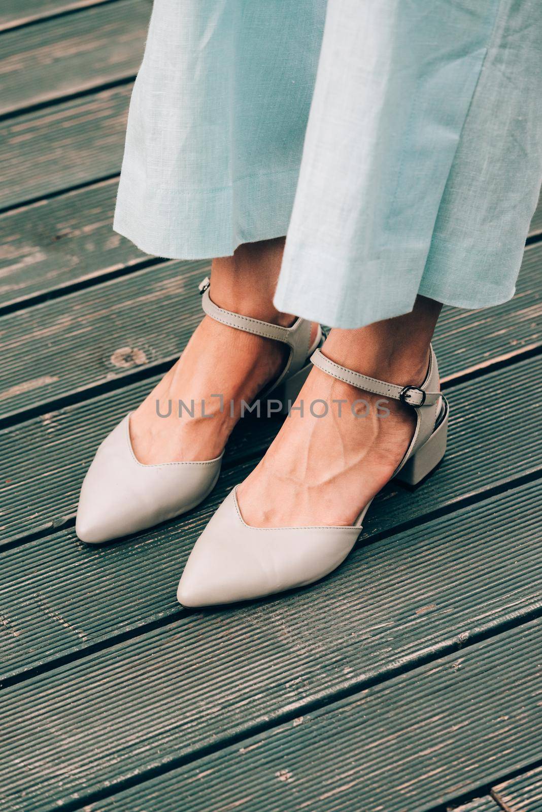 female legs in blue cotton pants and beige shoes by Ashtray25