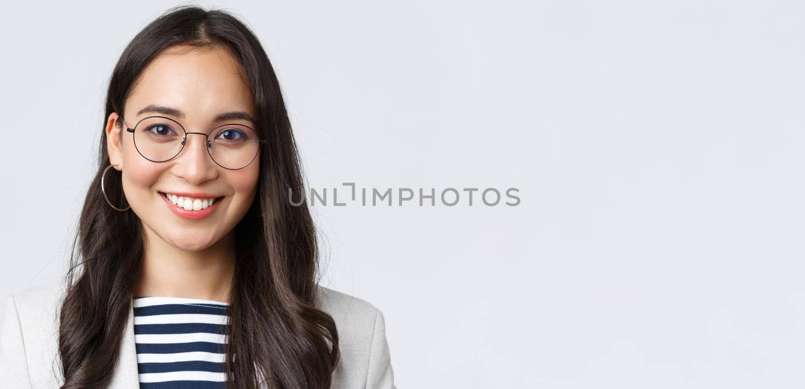 Business, finance and employment, female successful entrepreneurs concept. Close-up of smiling asian beautiful businesswoman wearing glasses and suit, looking confident and happy.