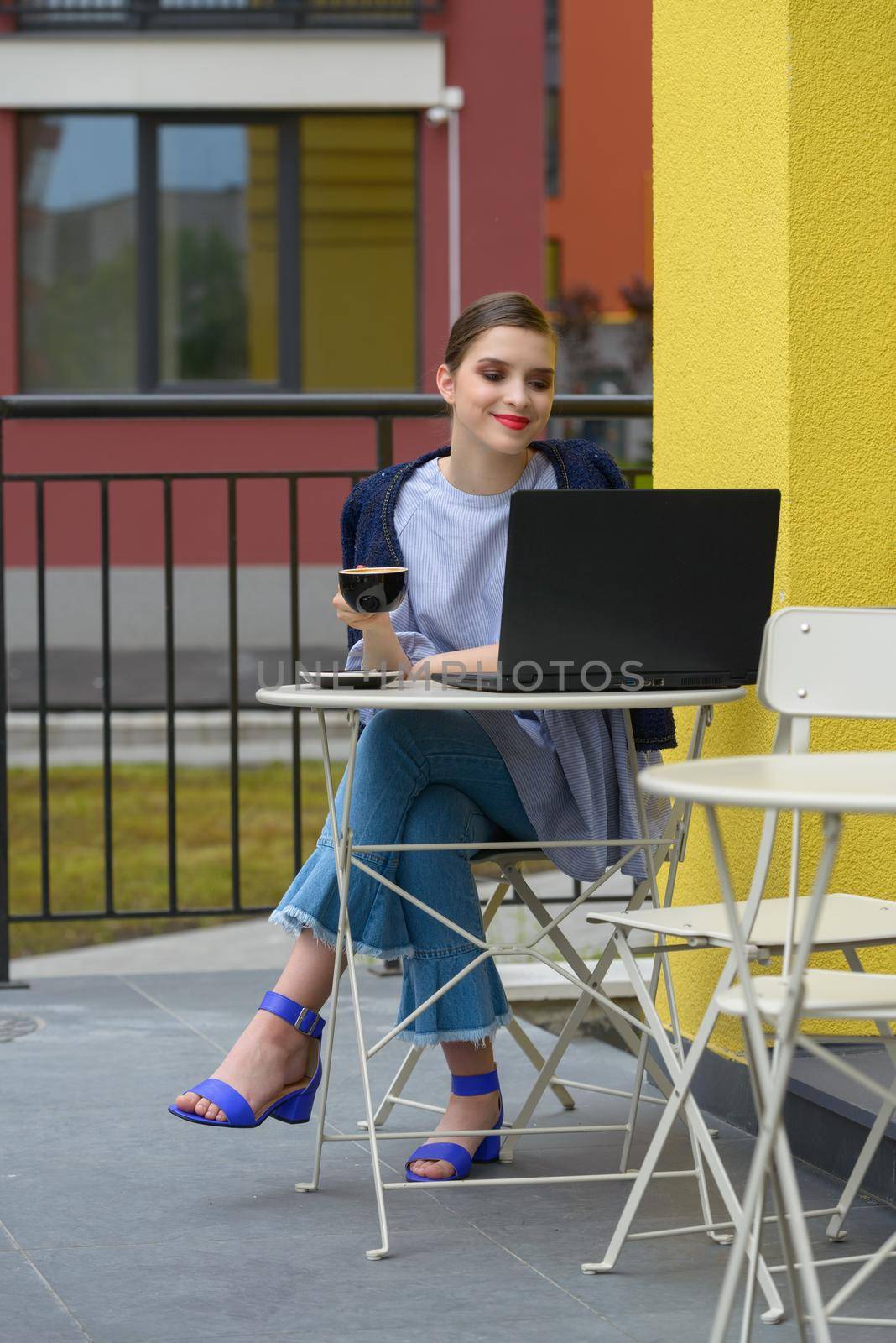 Charming happy woman student using laptop computer to prepare for the course work. by Ashtray25