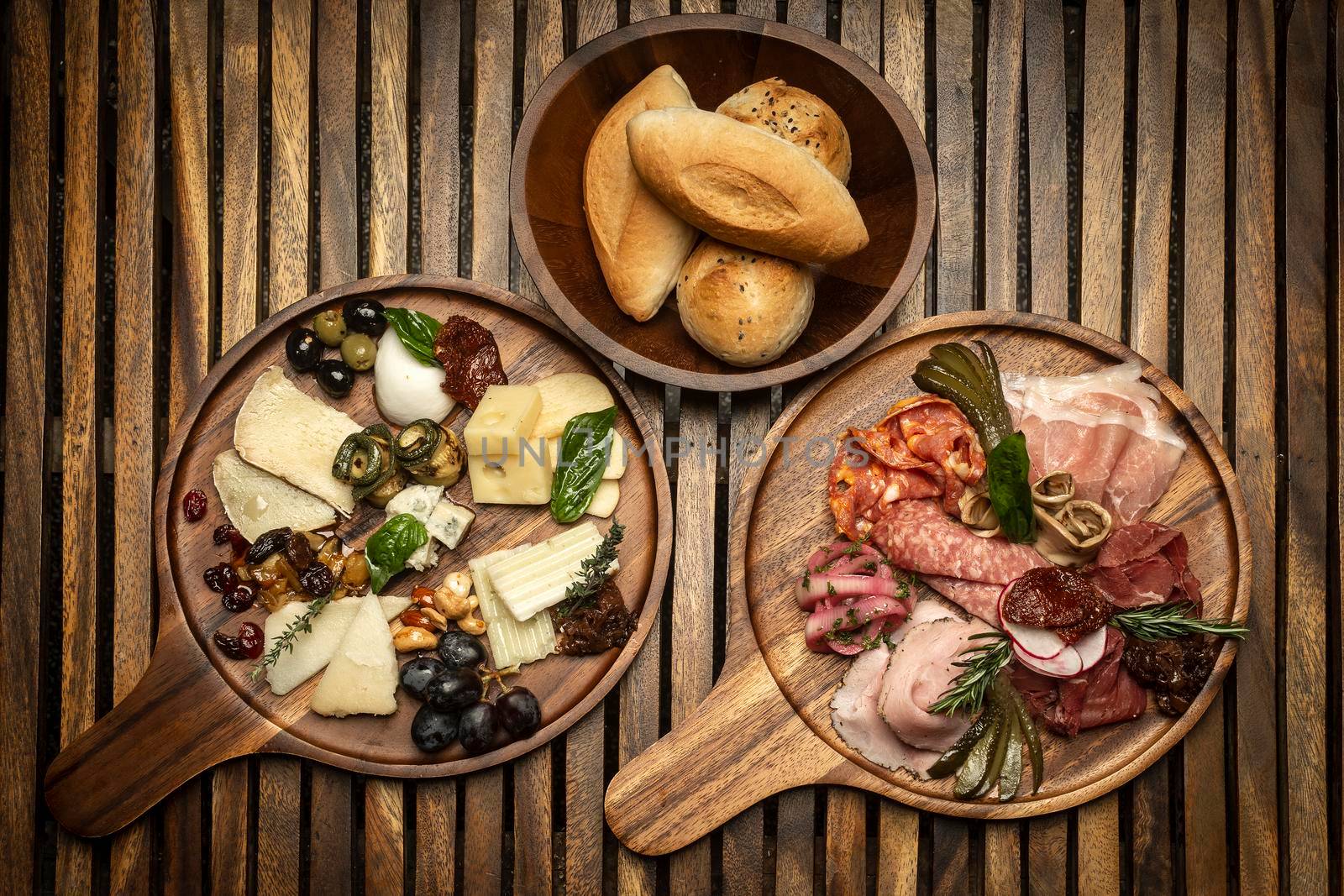 antipasto gourmet charcuterie and cheese cold cuts platter on wood board