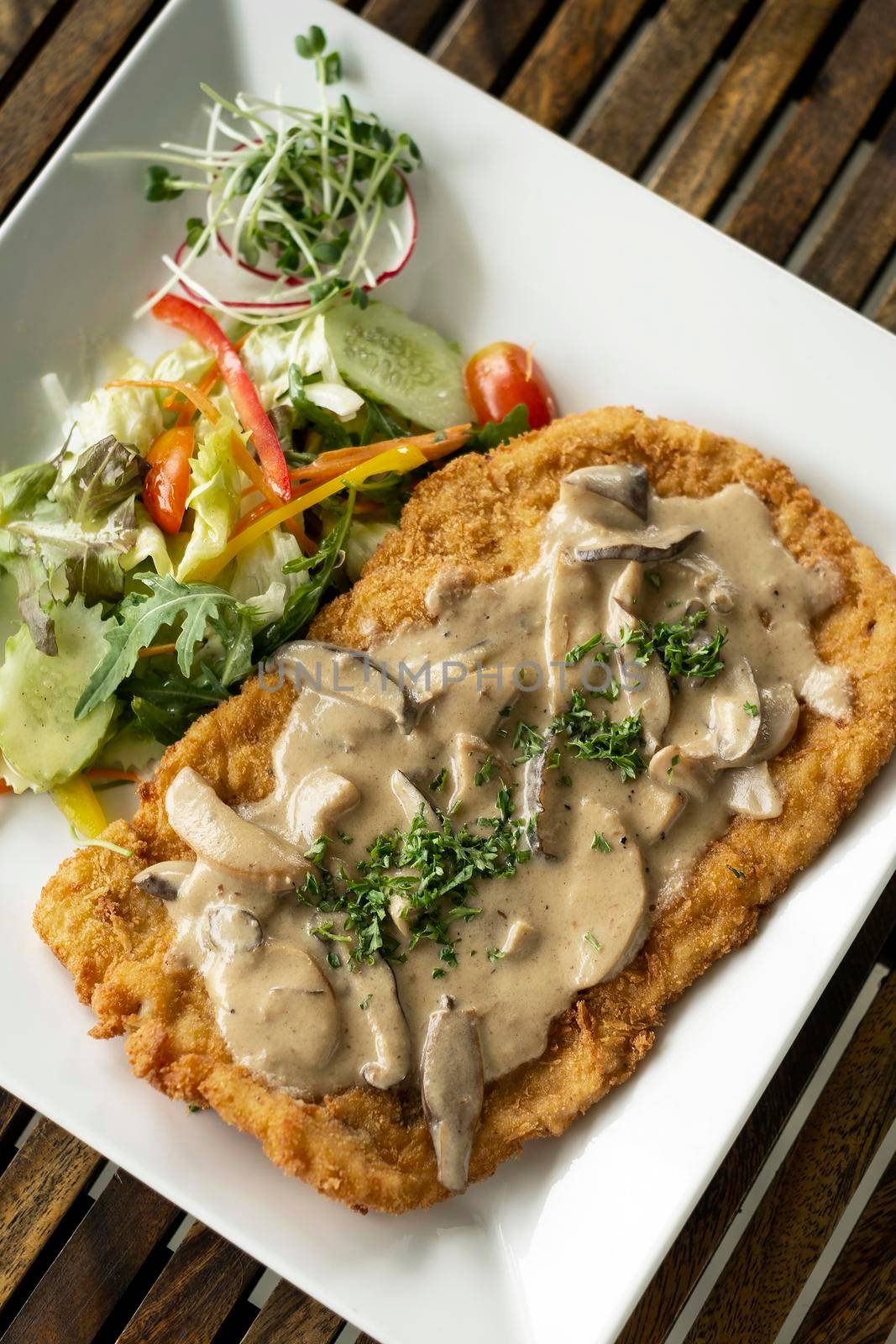 german veal Jagerschnitzel schnitzel cutlet with mushroom sauce and salad by jackmalipan