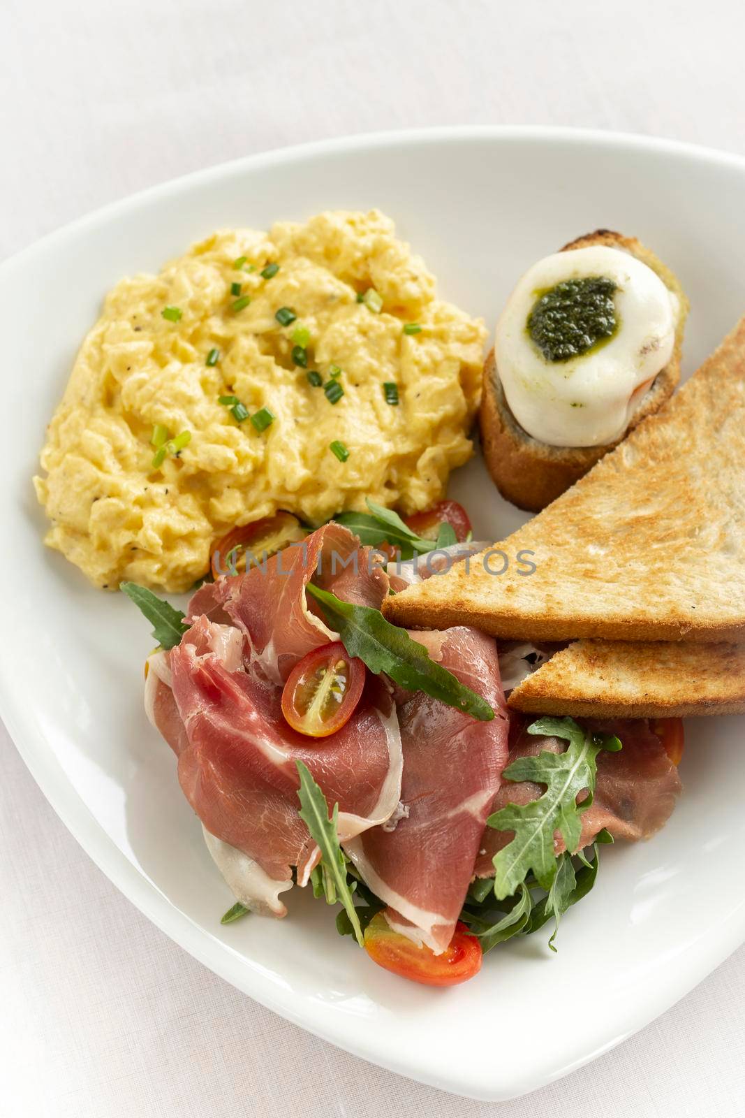 smoked jamon serrano ham and scrambled eggs gourmet breakfast in barcelona spain restaurant