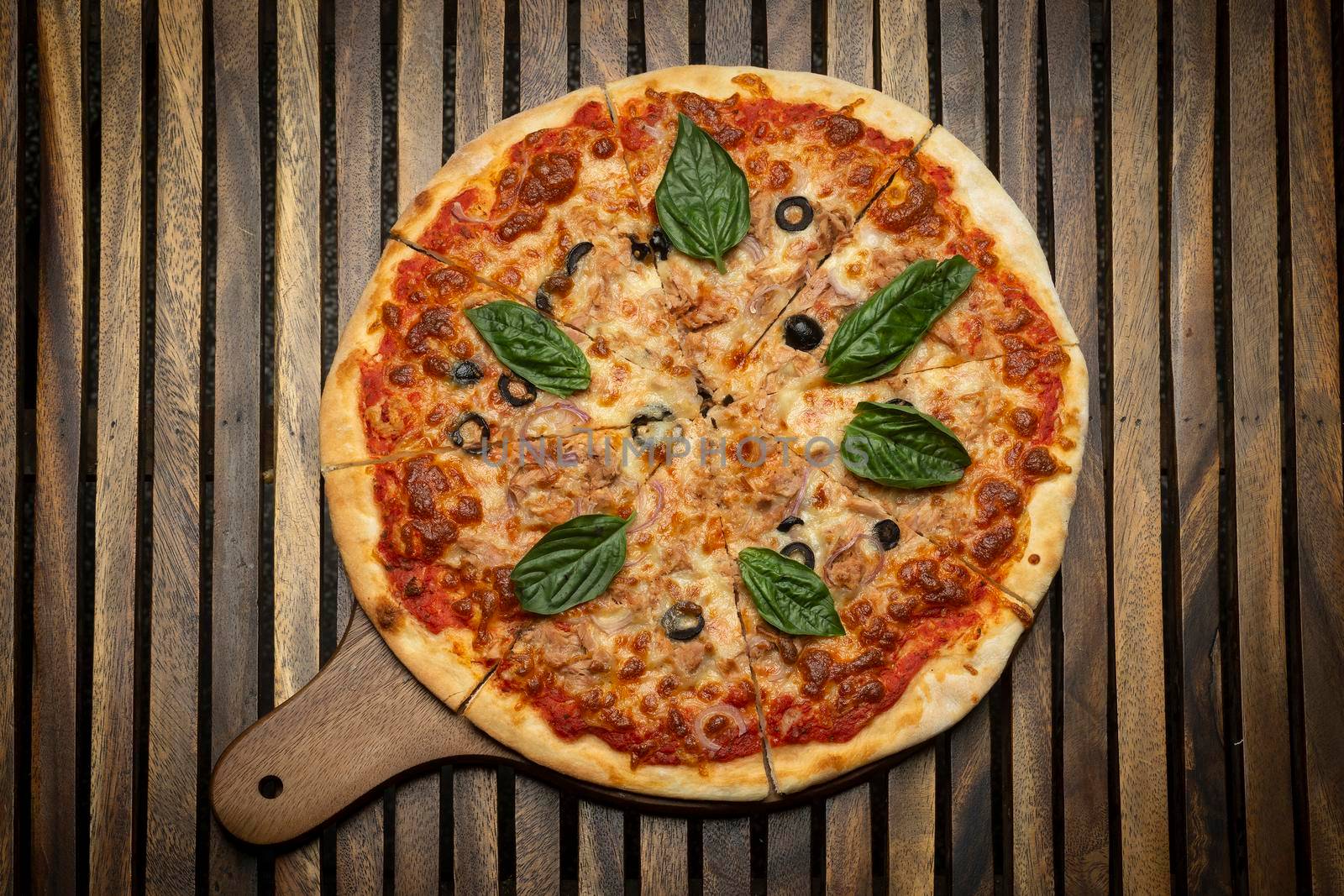 mixed organic vegetables vegetarian pizza on wood board by jackmalipan