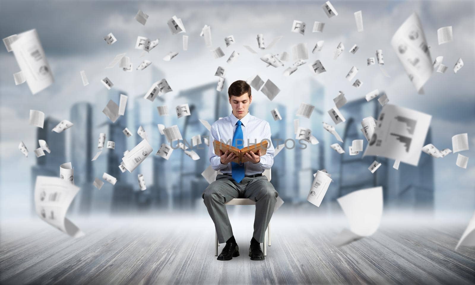 young businessman with book on office chair