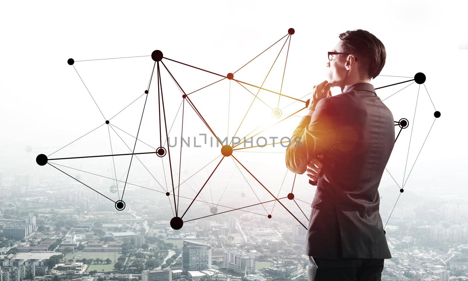 Young elegant businessman with hand on chin looking away