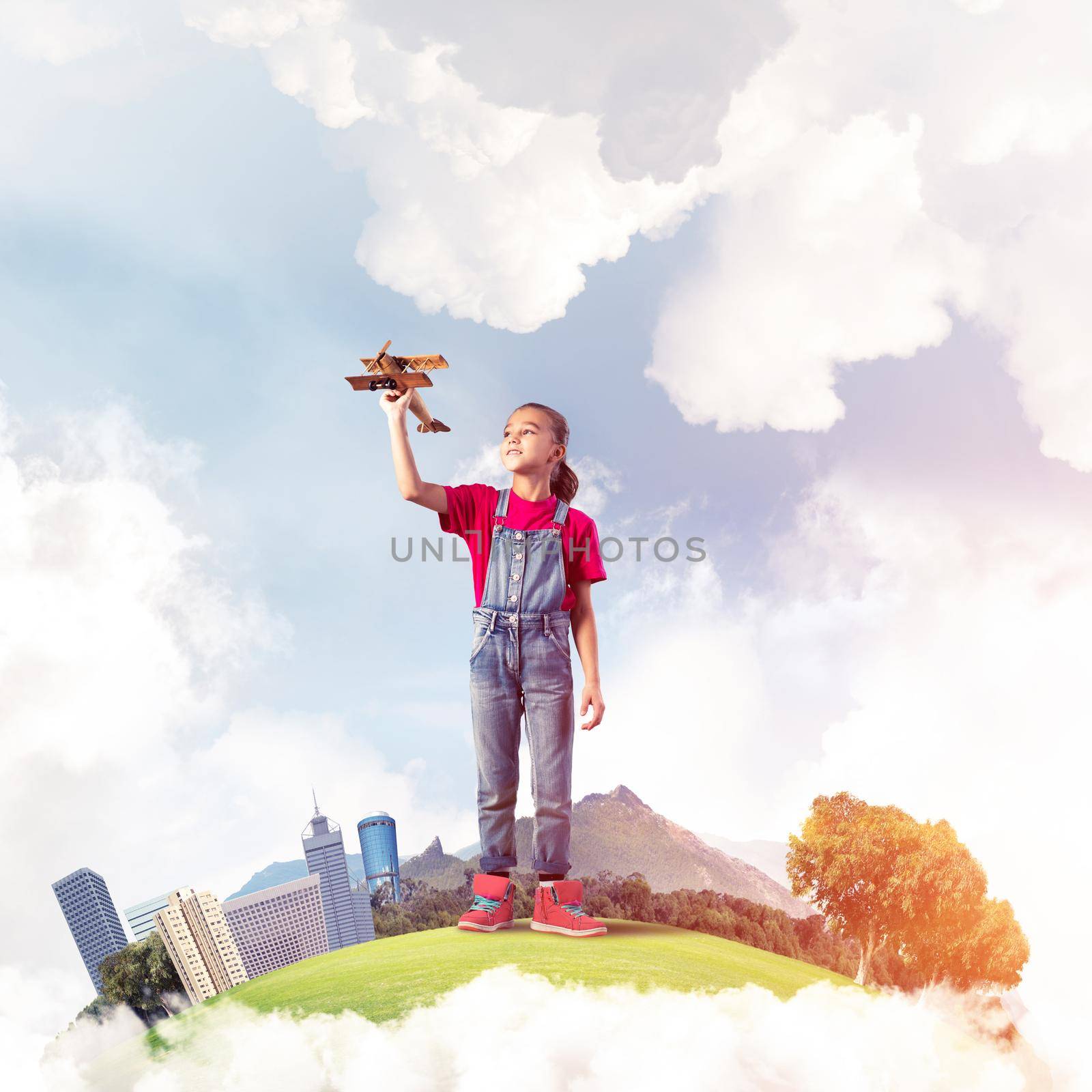 Concept of careless happy childhood with girl dreaming to become pilot by adam121