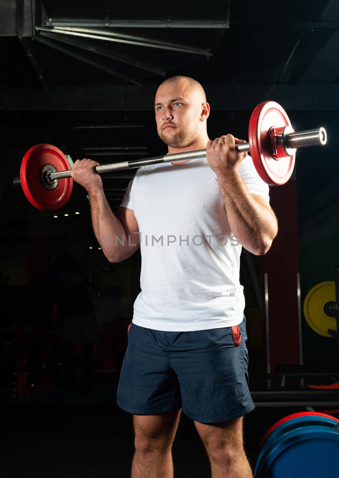 Man in the gym lifts the barbell. bodybuilding and healthy lifestyle